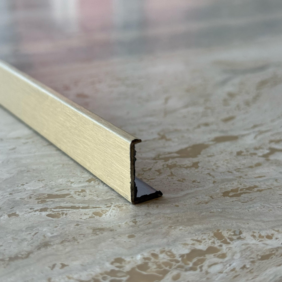 Gold stainless steel perforated profile, 0.8mm thick, designed for MDF wall panels, by BEACON, model PR0059.
