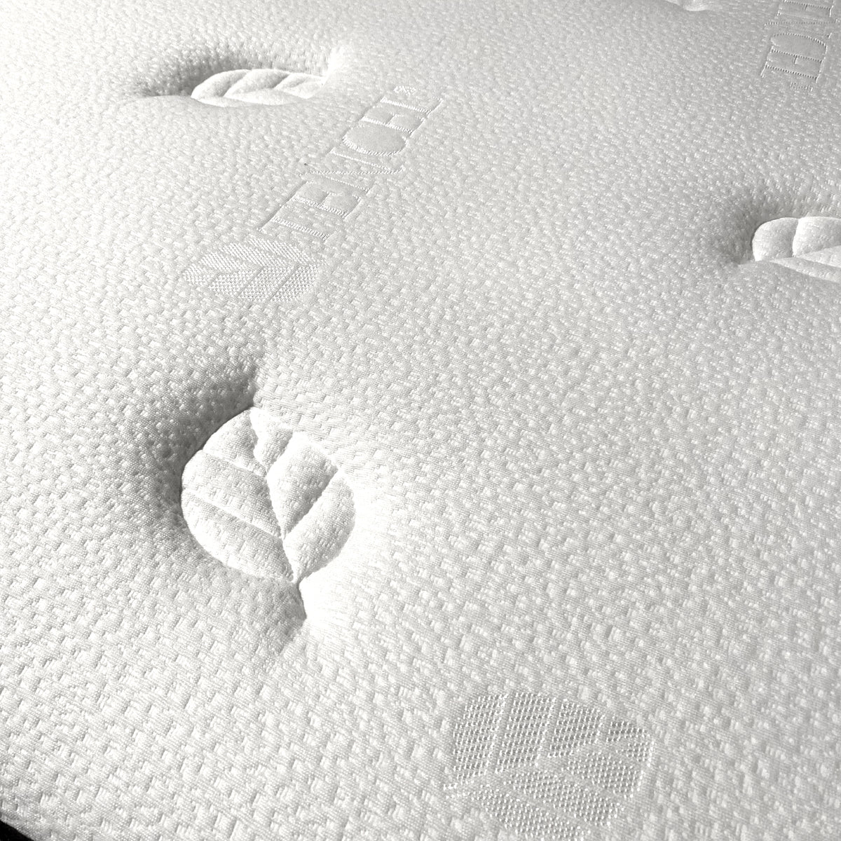 Display of a 180x200 cm latex king size mattress from Beacon, showing the top surface and plush fabric texture.