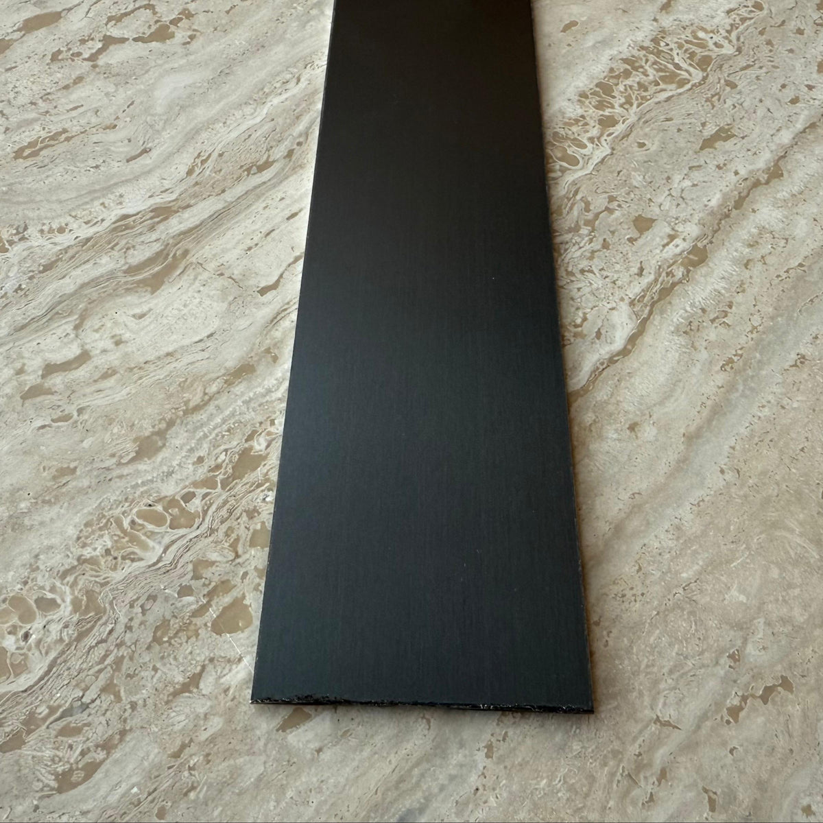 Black stainless steel wall panel profile, 1mm thick, 5cm width, from BEACON, used for wall paneling and architectural finishes.