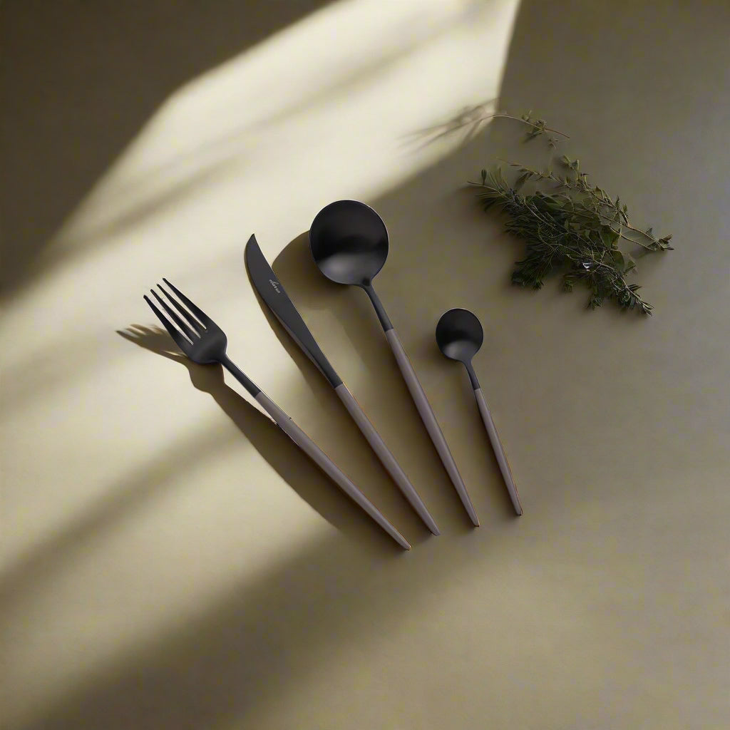 24-piece BEACON Glint cutlery set with stainless steel forks, knives, and spoons arranged neatly on a table.