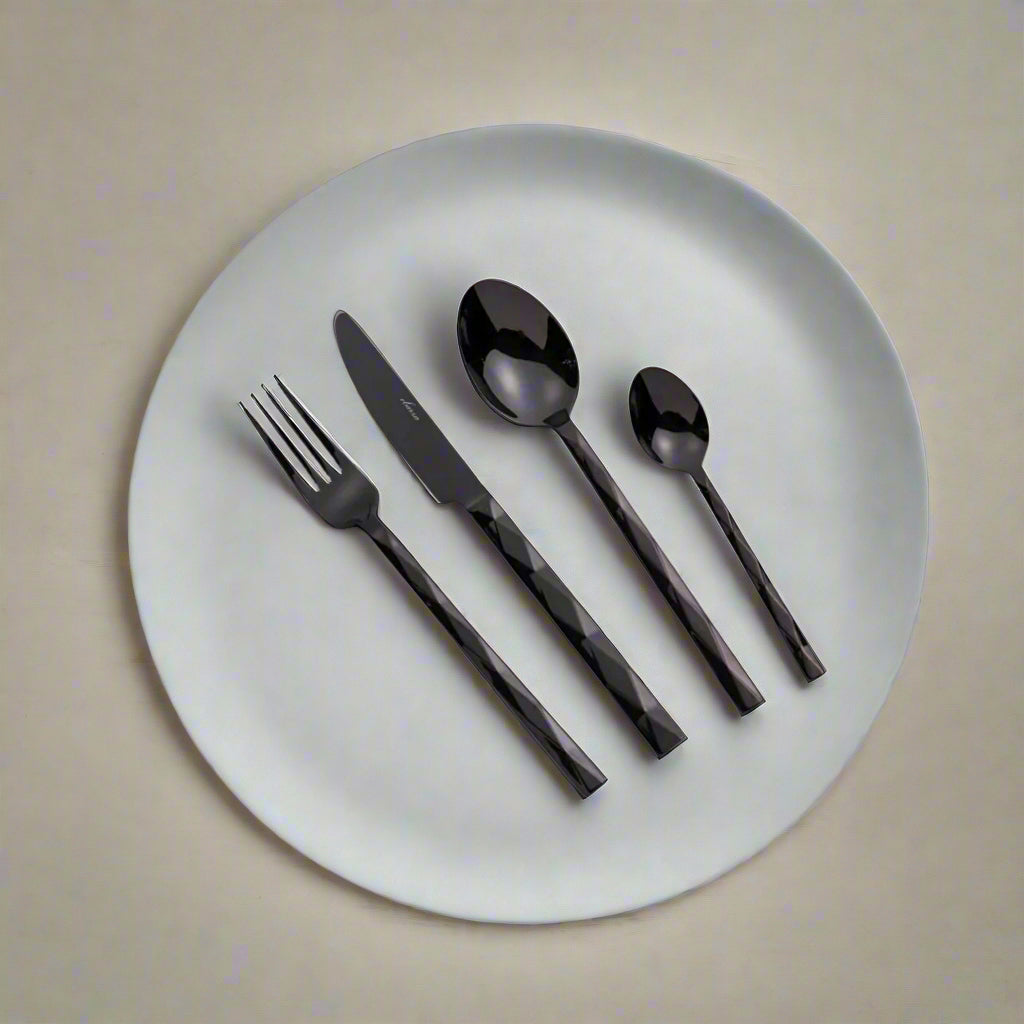 24-piece Vero cutlery set by BEACON featuring stainless steel forks, knives, and spoons arranged on a dining table.