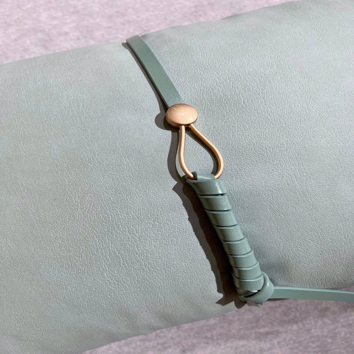 Beige 30x60 Cecil Belt Cushion by BEACON, featuring a soft fabric cover and decorative belt design for modern home decor.