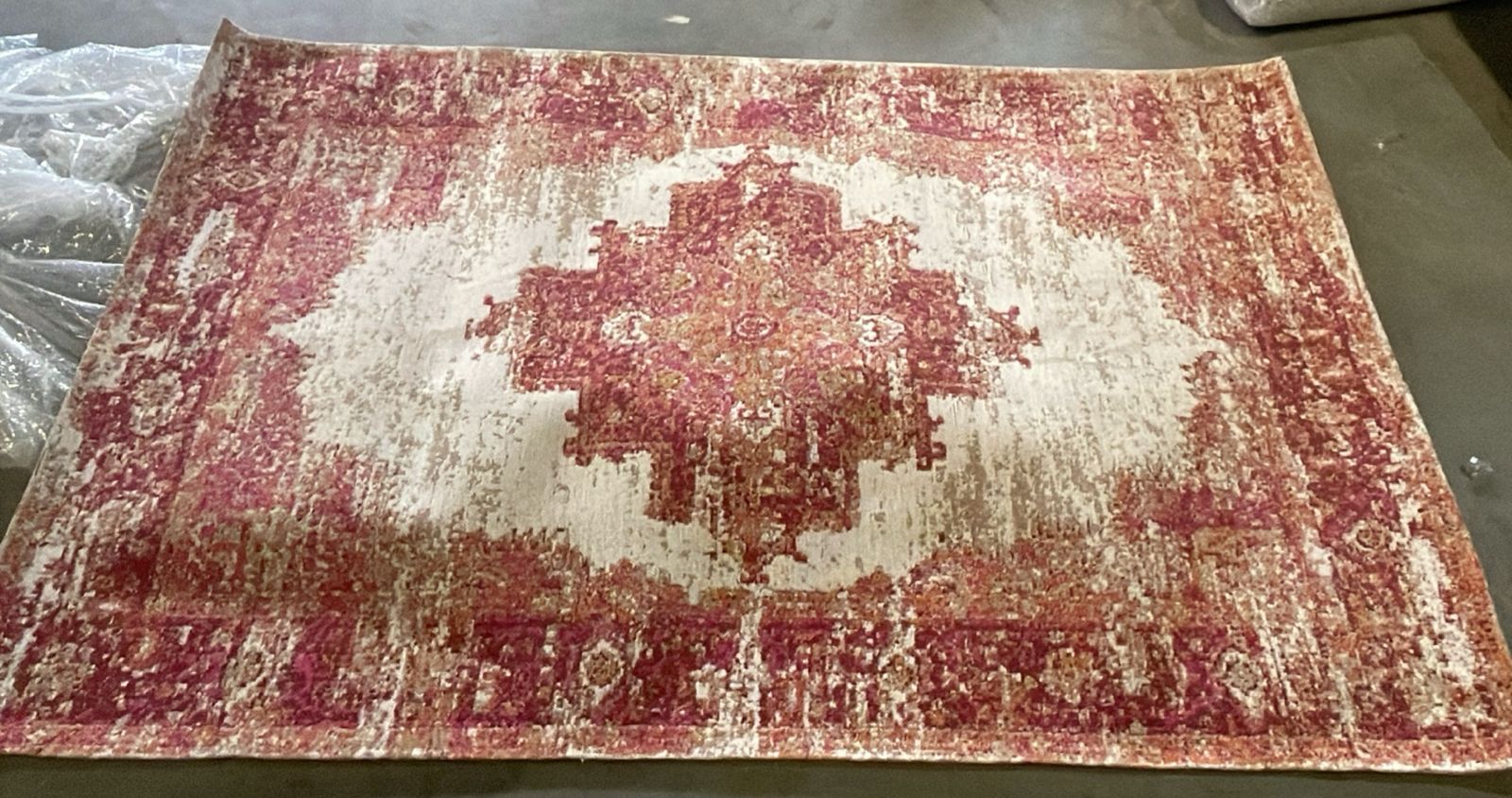 Handmade 230x160 cm Melenia rug by Javi, display item with intricate patterns and vibrant colors on a textured surface.