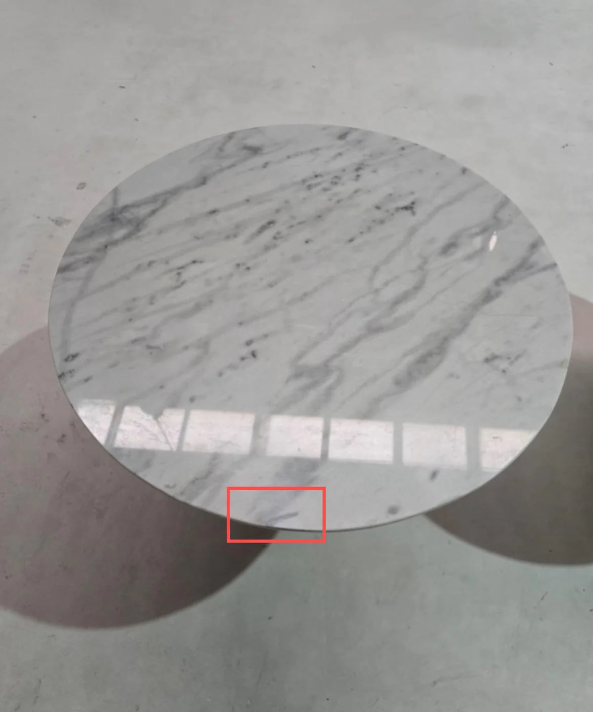 Display image of the AS IS Madrid natural marble dining table by Beacon, featuring a polished marble surface and sturdy wooden legs.