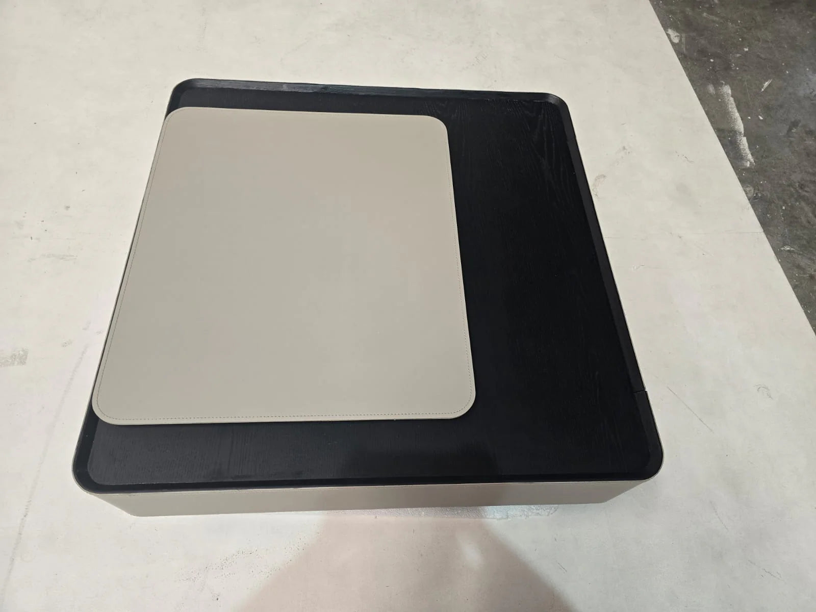 Display image of saddle leather veneer coffee table by BEACON, showcasing its rustic wooden frame and smooth leather surface.