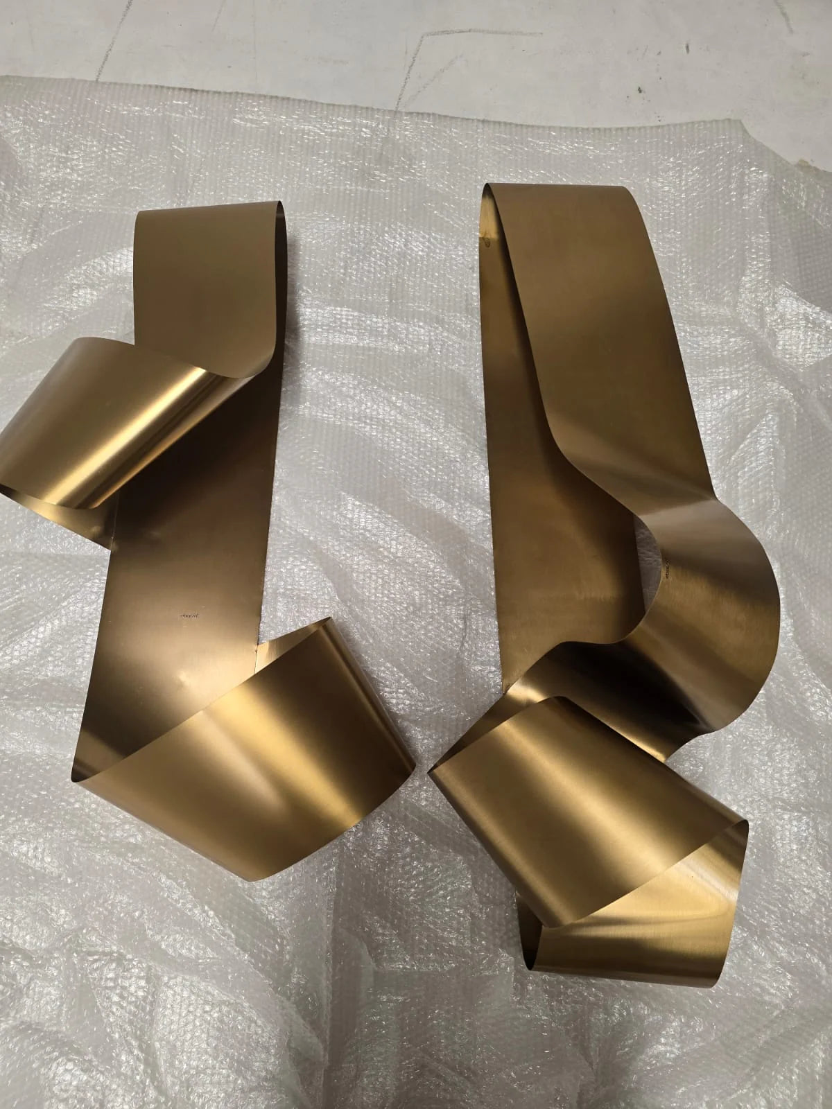 Set of 2 handcrafted stainless steel gold artwork display items by BEACON, featuring modern artistic designs.