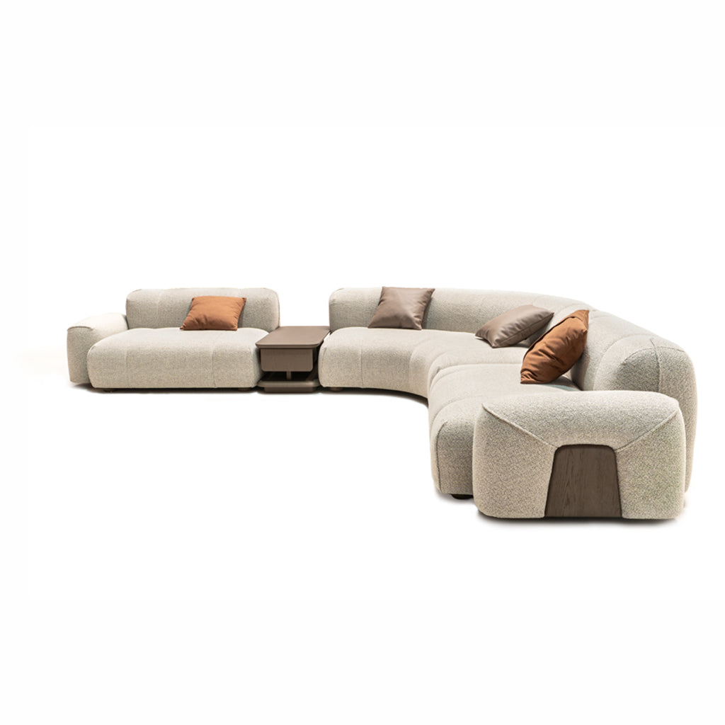 Modern bold corner sofa with matching coffee table by HOMAGE KOLTUK, featuring plush cushions and sleek wooden legs.
