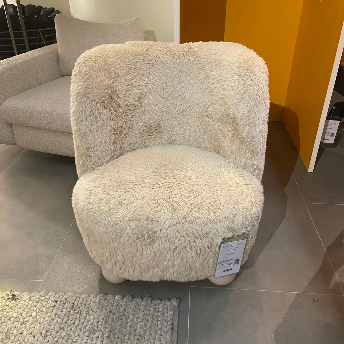Ivory ball-foot accent chair by Sagebrook Home, showcasing a stylish modern design with round wooden legs and plush upholstery.