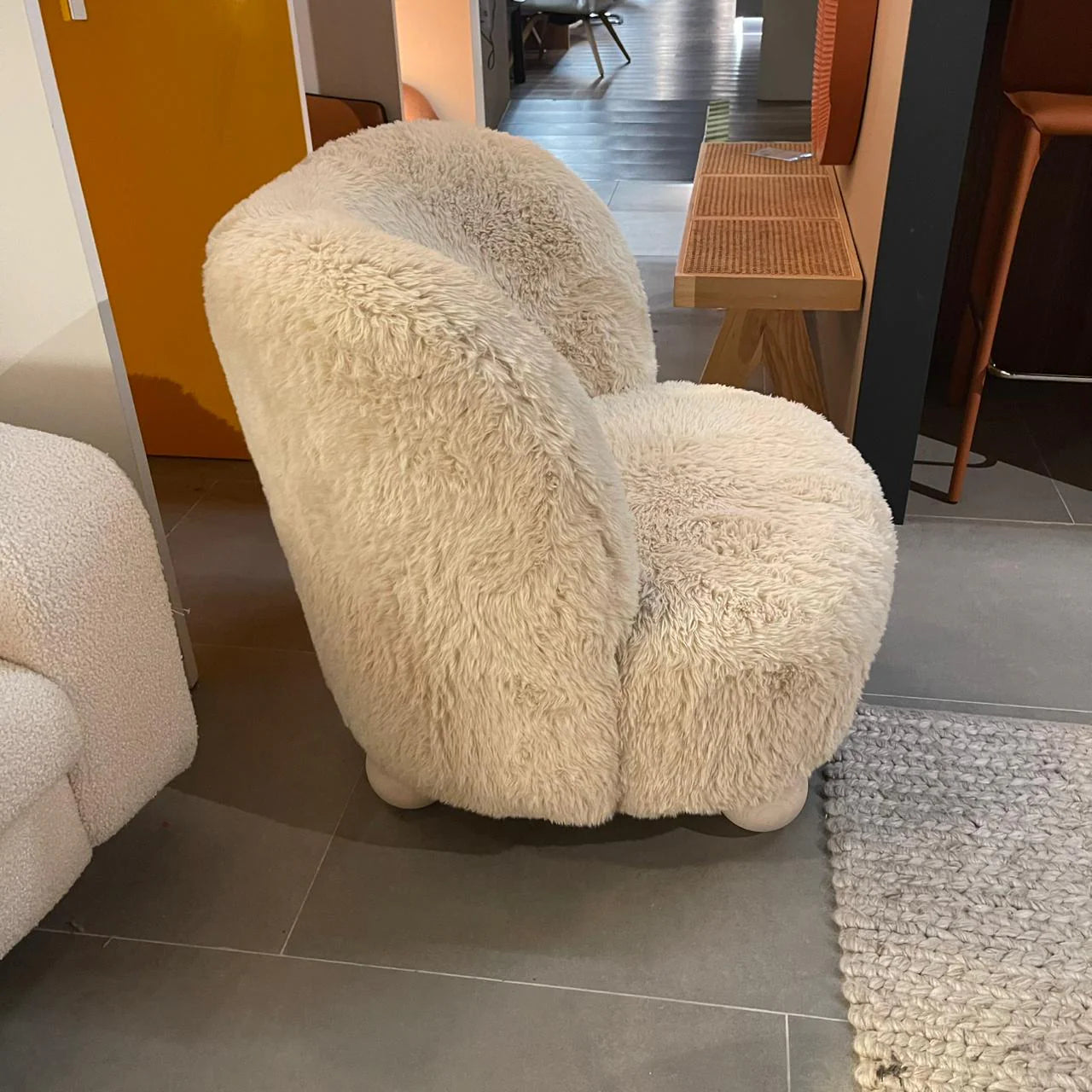 Ivory ball-foot accent chair by Sagebrook Home, showcasing a modern design with round wooden legs and plush upholstery.