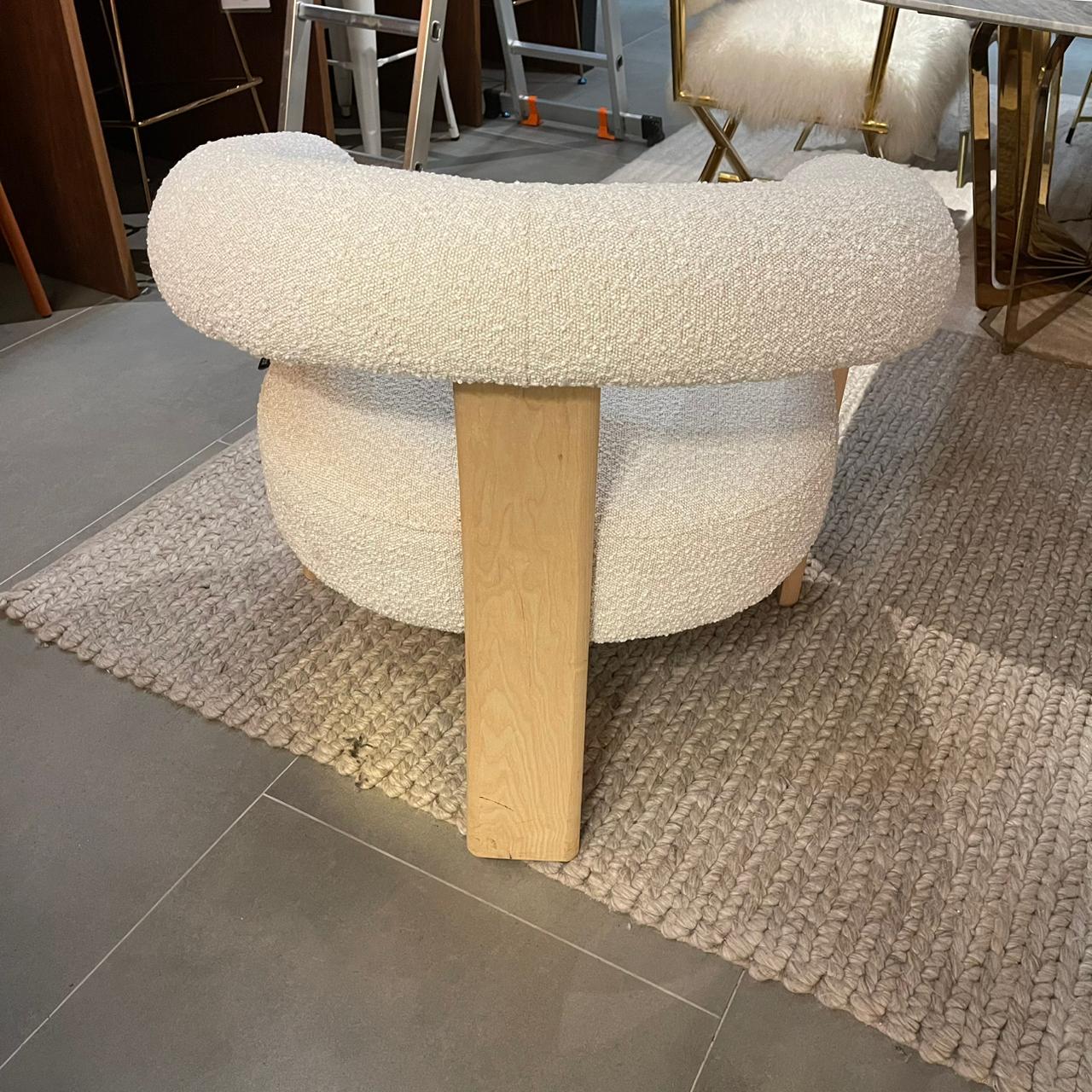 Display of Sagebrook Home curved back wishbone chair with brown oak legs, showcasing elegant design and craftsmanship.