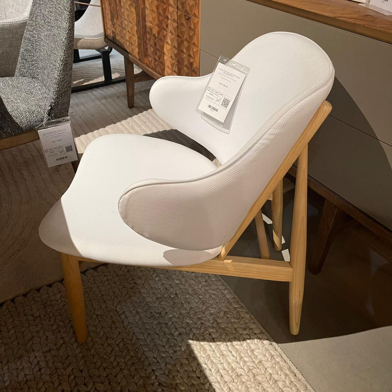 Display of a lounge chair with a solid ash wood base from BEACON, featuring a sleek and modern design.