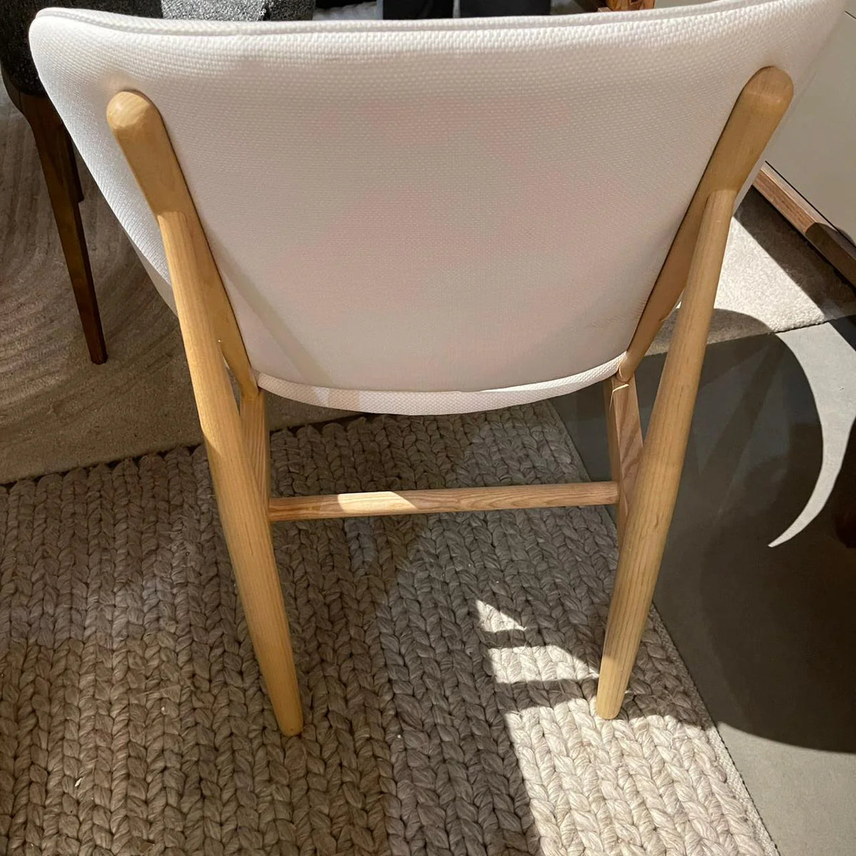 Display lounge chair with solid ash wood base and purple upholstery by BEACON, perfect for modern living spaces.