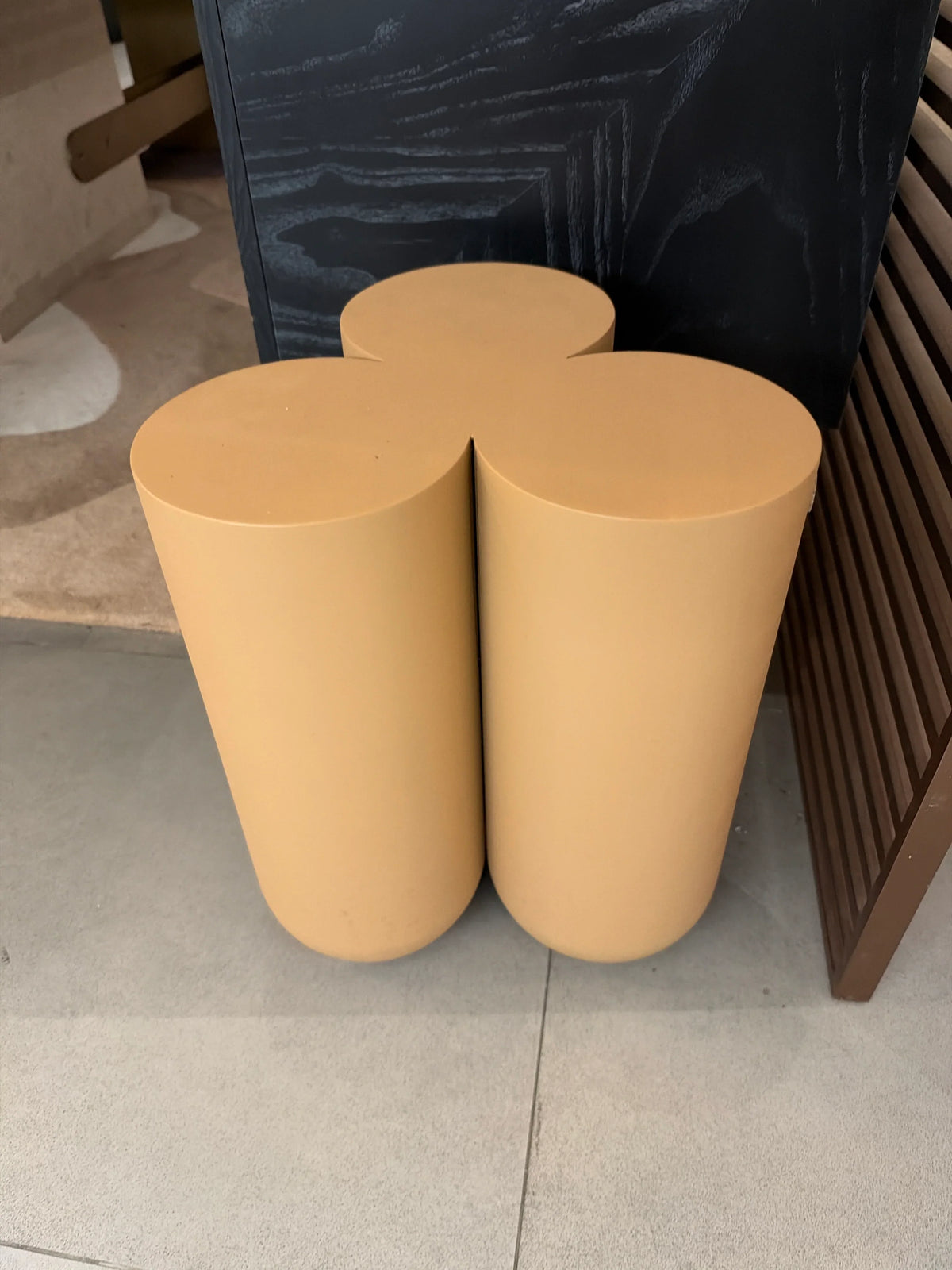 Display image of a beige side table made of oak wood and bent wood, showcasing a modern design by Beacon.