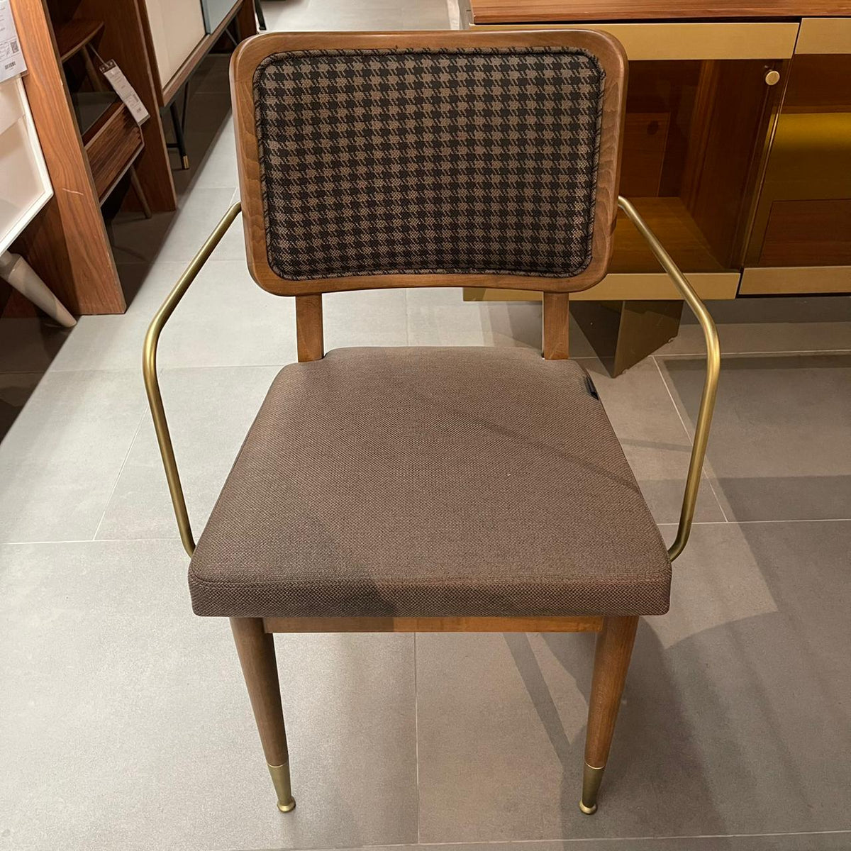 Display of a Soho-Gold dining chair by LODA Furniture, showcasing a modern gold-toned chair with a sleek design and comfortable seating.