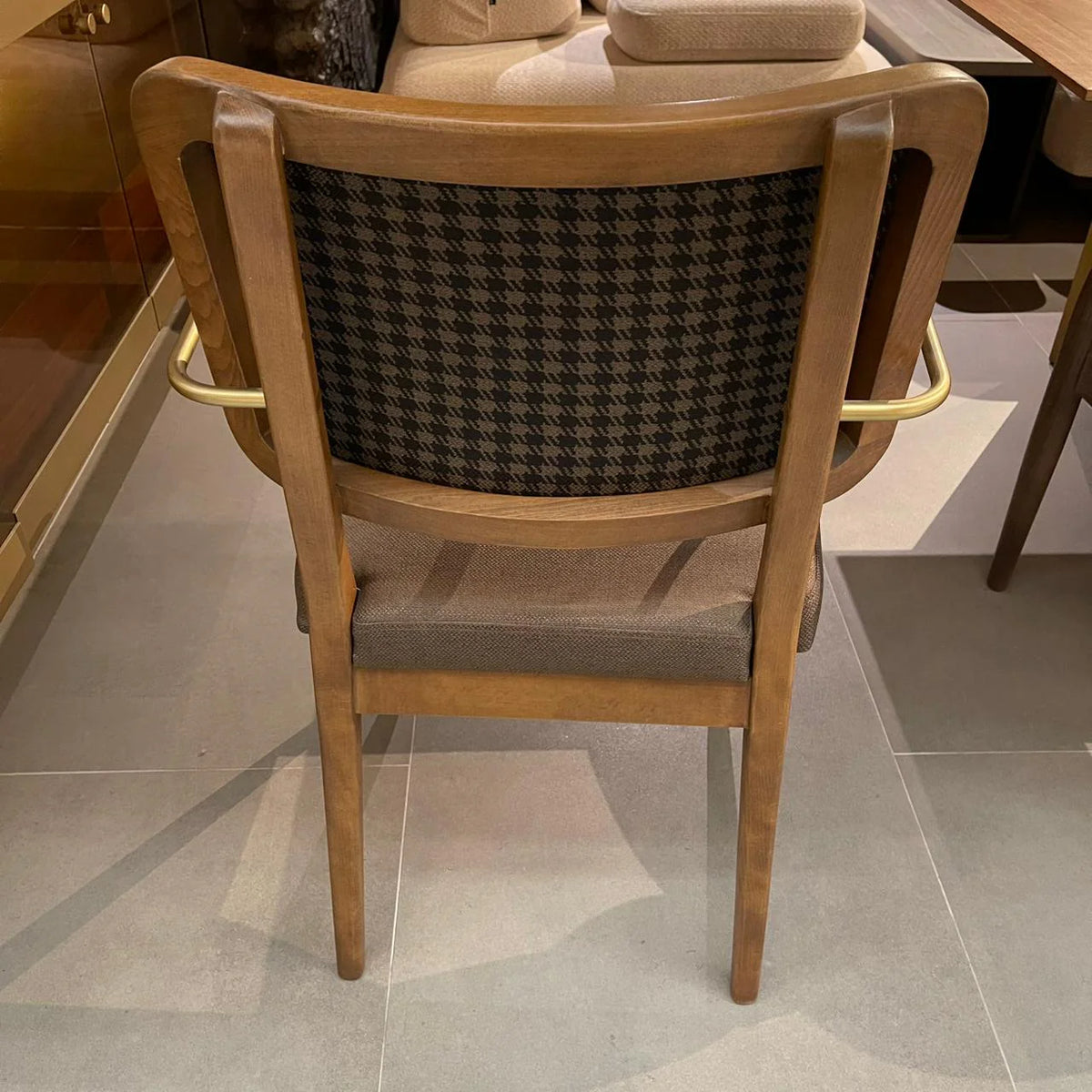 Display of a Soho-Gold dining chair by LODA Furniture, showcasing its elegant gold finish and modern design.