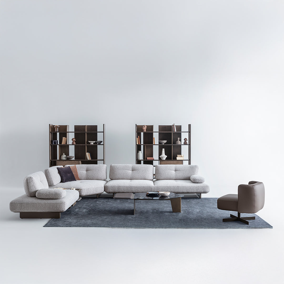 Modern gray sectional sofa with a side chair on a white background