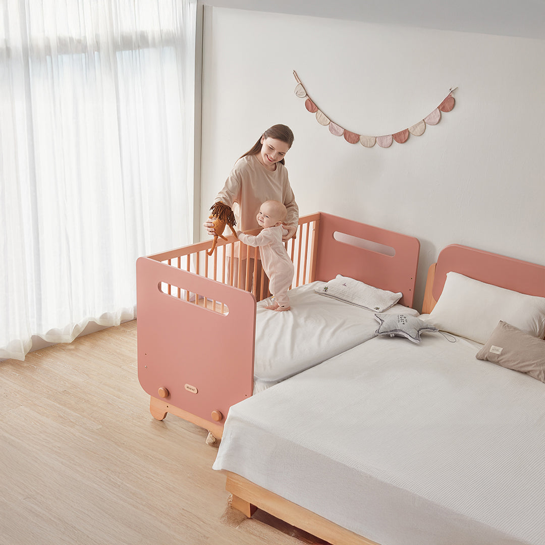 Kids Yarra bedside bed by BOORI in cream and black, featuring a sturdy wooden frame with safety rails and a convenient storage drawer.