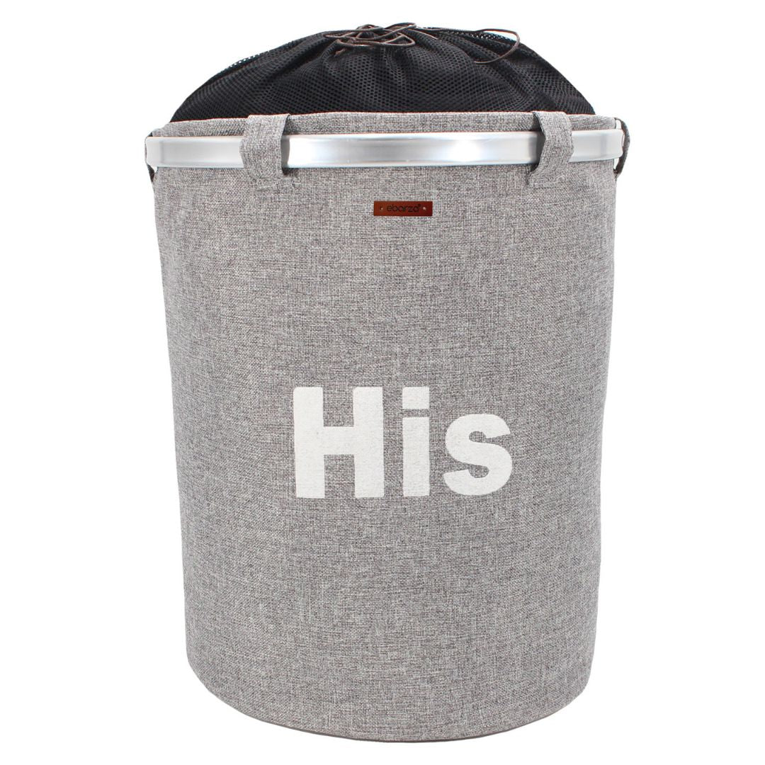 Round Terra laundry storage basket by BEACON, made of durable material, featuring a modern design and handle openings for easy carrying.