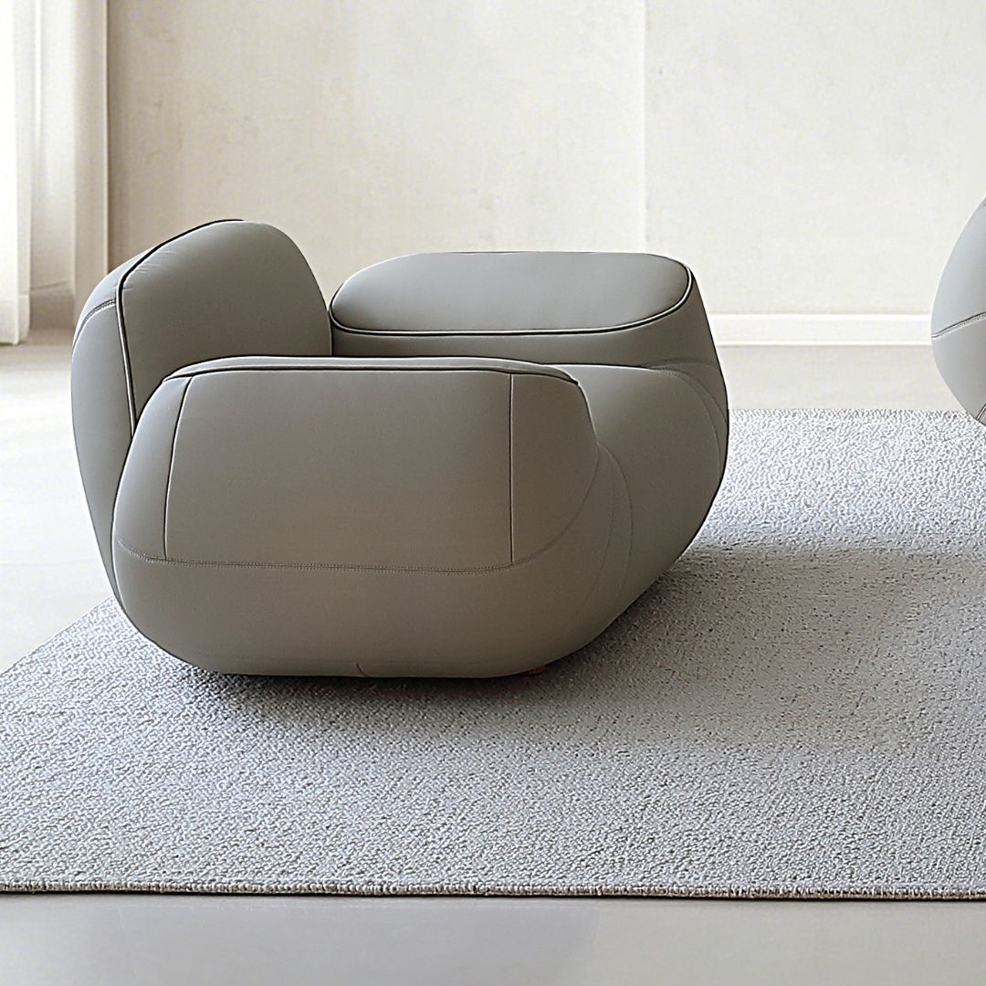 BEACON Rotunda armchair AMCJ-S6102 with plush fabric upholstery and curved arm design, shown from a front angle.