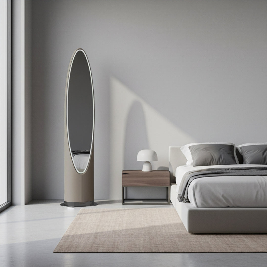 Stainless steel floor mirror with a sleek, modern frame, reflecting a room with neutral decor.