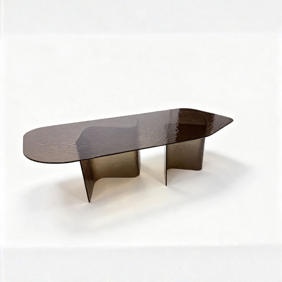 A modern coffee table with a translucent dark brown smoked glass top and matching sculptural pedestal bases, photographed on a seamless white studio background.