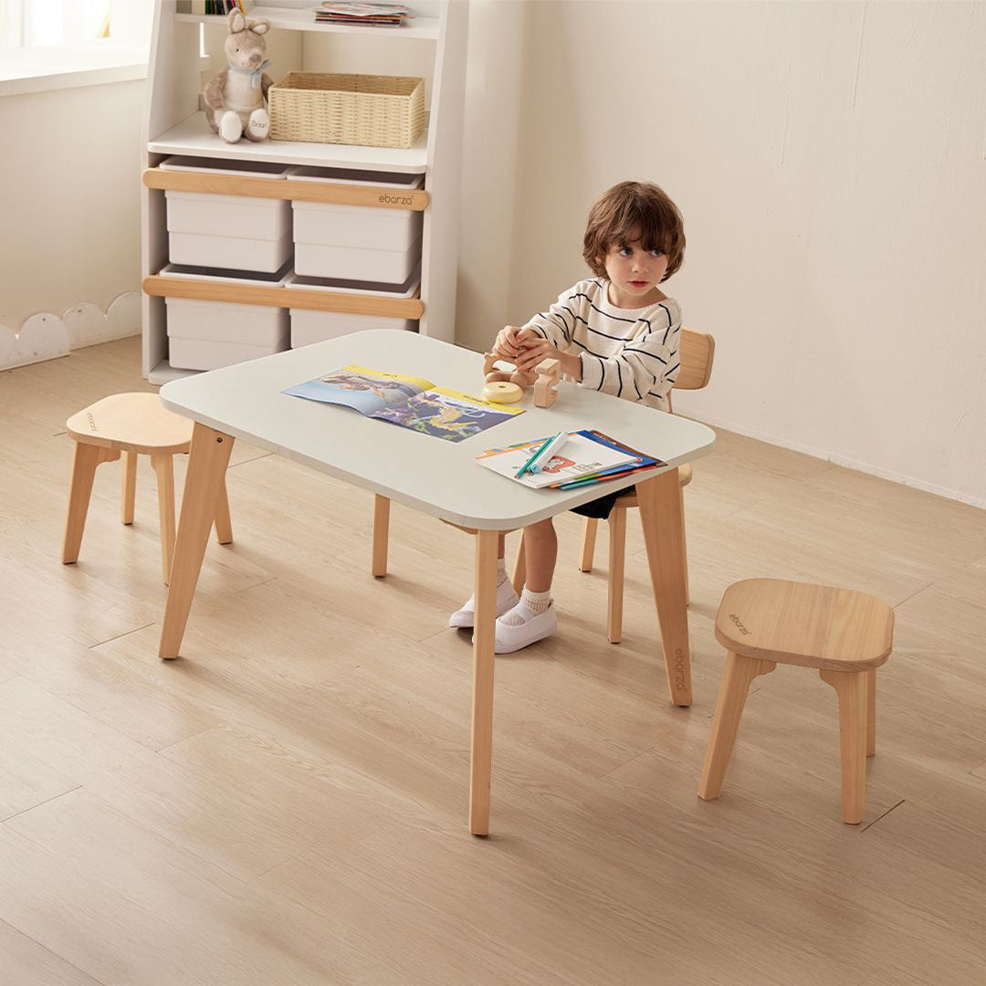 Wooden Tidy Kid low stool by BOORI, designed for kids' tables, shown in natural wood finish with smooth edges.