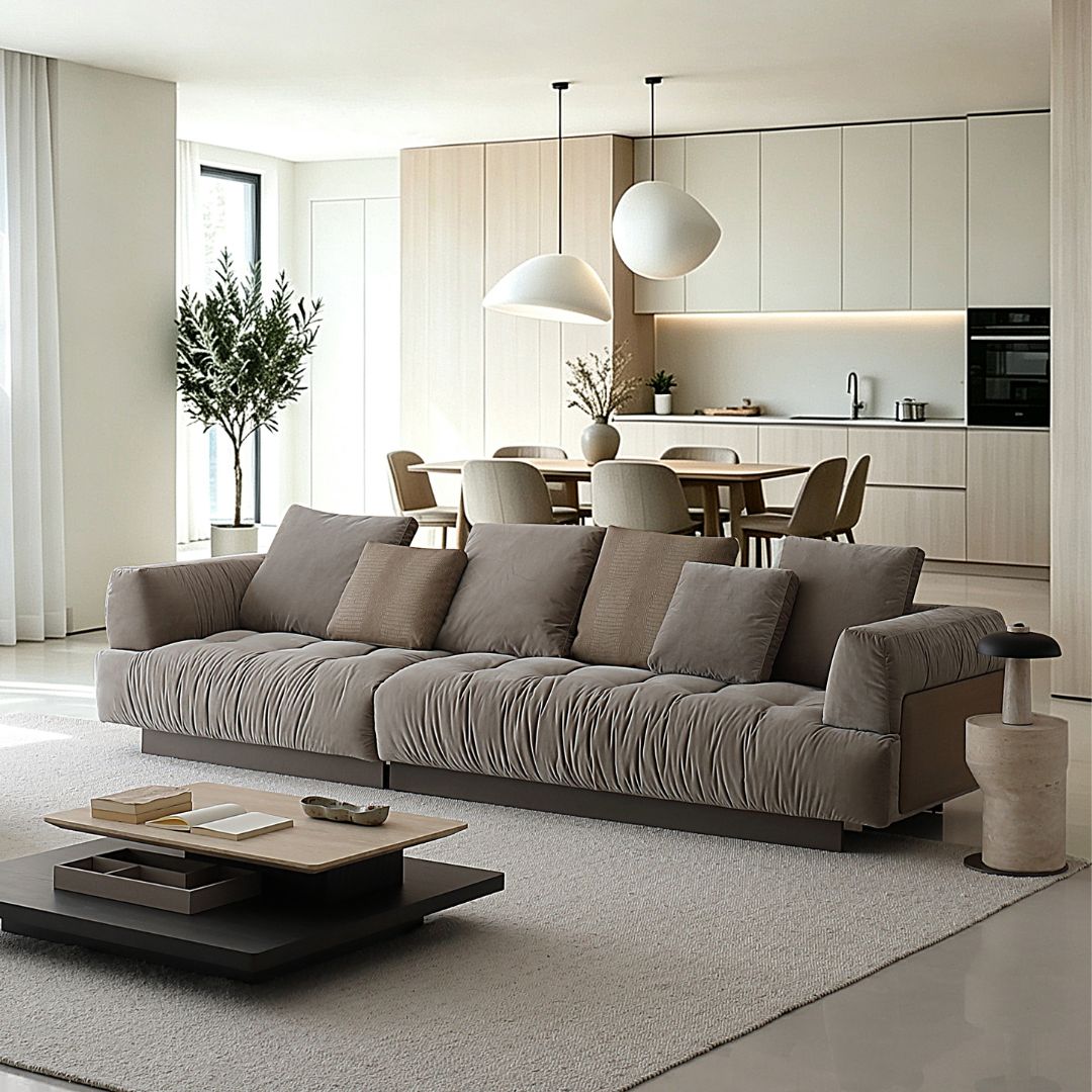 BEACON Volute sofa with matching ottoman, featuring sleek cushions and modern design in a stylish living room setting.