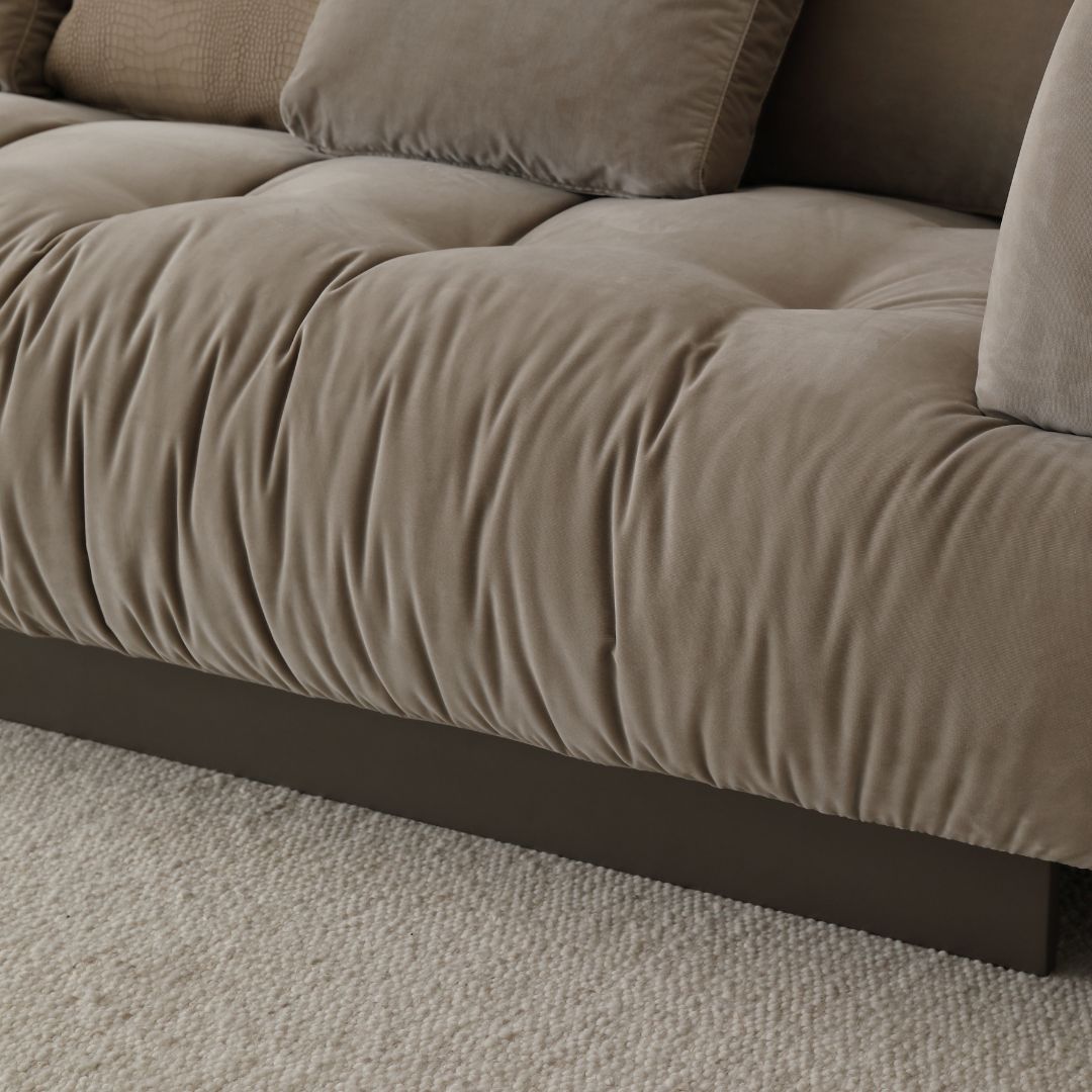 BEACON Volute sofa with matching ottoman, featuring plush cushions and modern design in a contemporary living room setting.