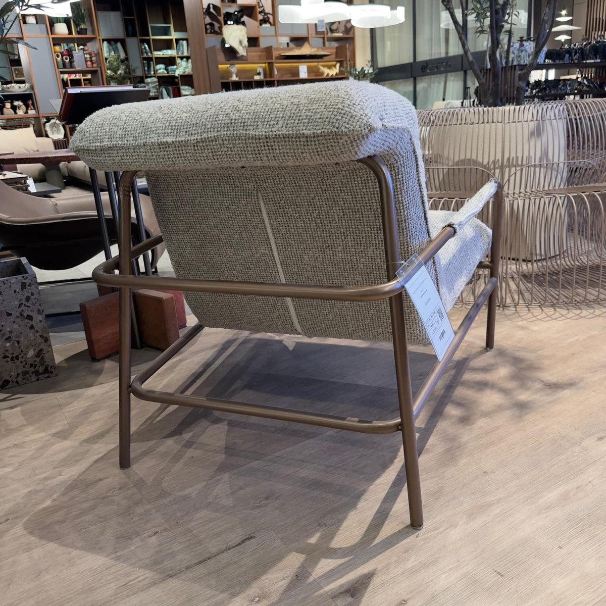 HOMAGE KOLTUK Gamma Armchair display item with modern design, upholstered in fabric, showcasing its sleek shape and comfortable seating.