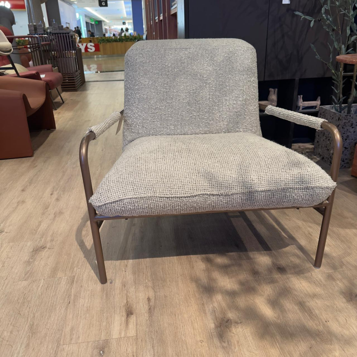 Gamma armchair by Homage Koltuk, showcasing modern design with plush upholstery and sleek wooden legs.
