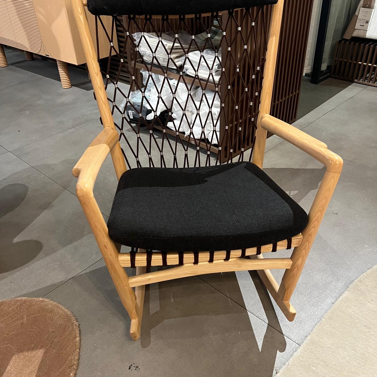 Solid wood and cord lounge chair by RUDI, display item, featuring a modern design with a wooden frame and woven cord seating.