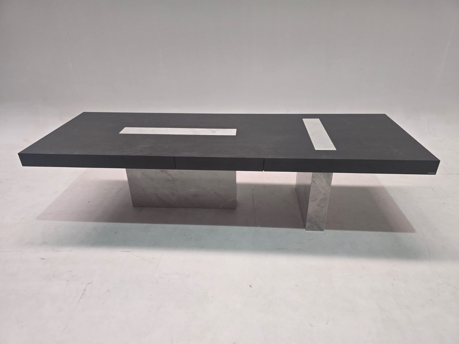 Dark Emperador rectangular dining table by Beacon, display model with a polished stone top and sturdy wooden legs.
