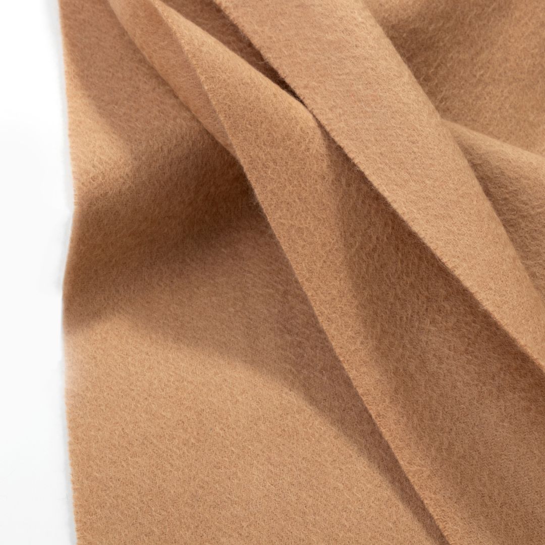 Beige Lana Wool Scarf by BEACON, featuring soft, cozy wool fabric and fringed edges, displayed flat.