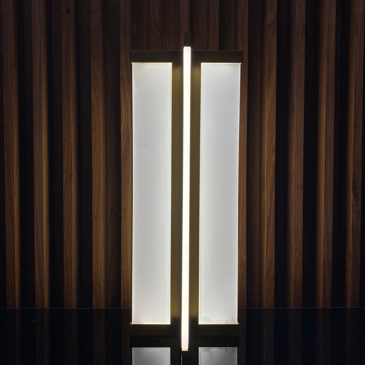 Golden Beacon table lamp display item with a sleek, modern design and a warm golden finish.