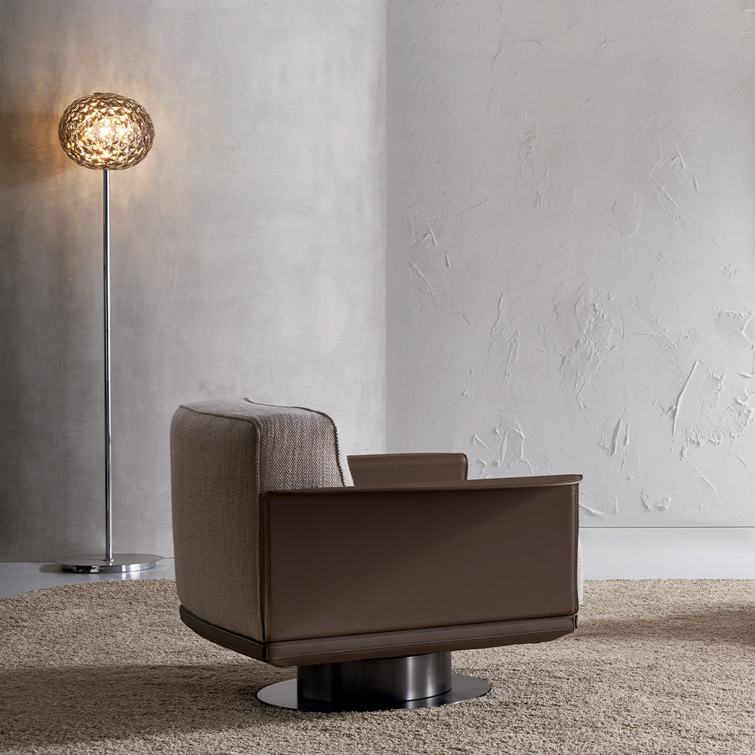 A modern BEACON Avenor armchair with plush fabric upholstery and sleek design, perfect for living rooms or cozy seating areas.