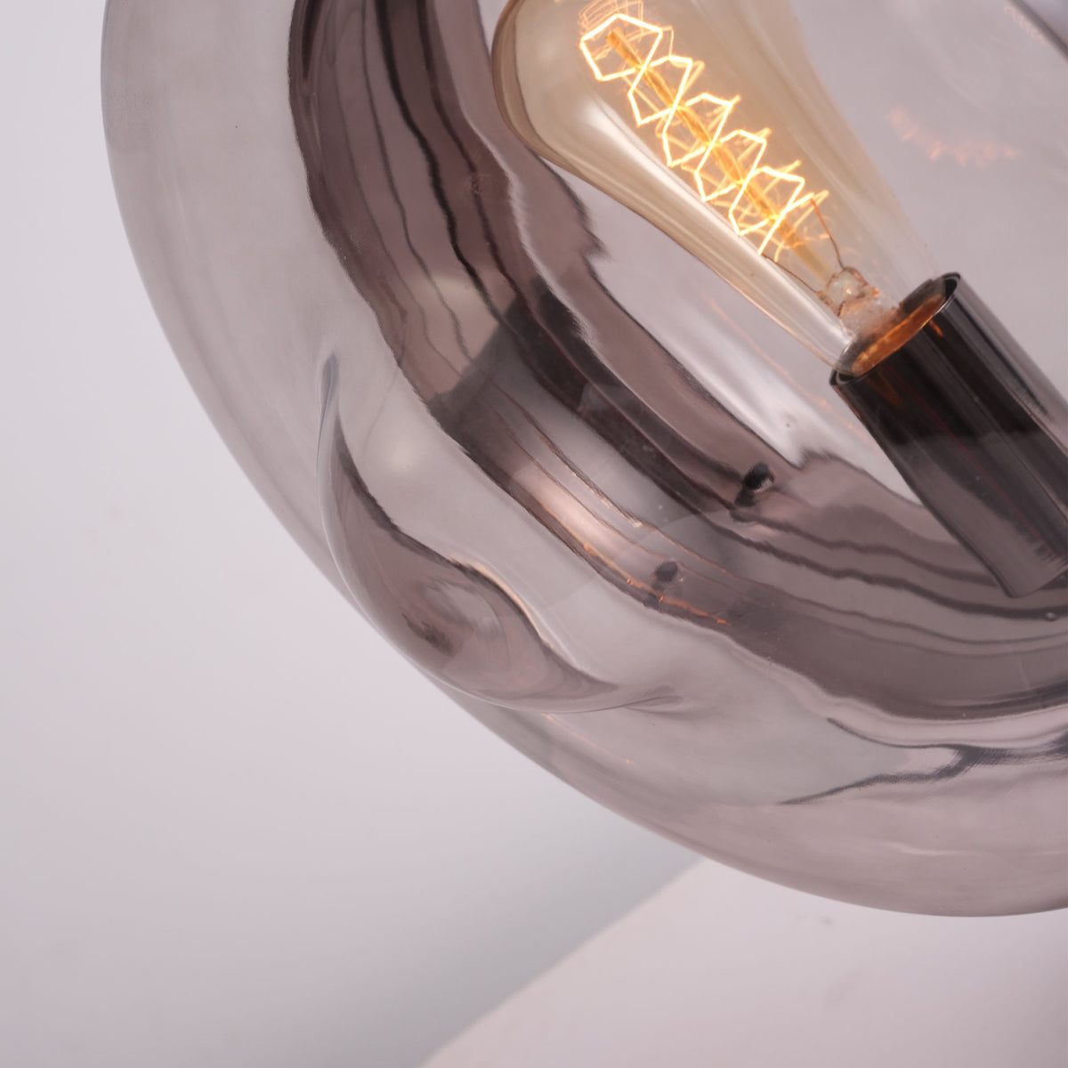 BEACON Cosmos Orb table lamp CY-TD-1049 on a desk, featuring a spherical design with a warm glow, ideal for modern decor.