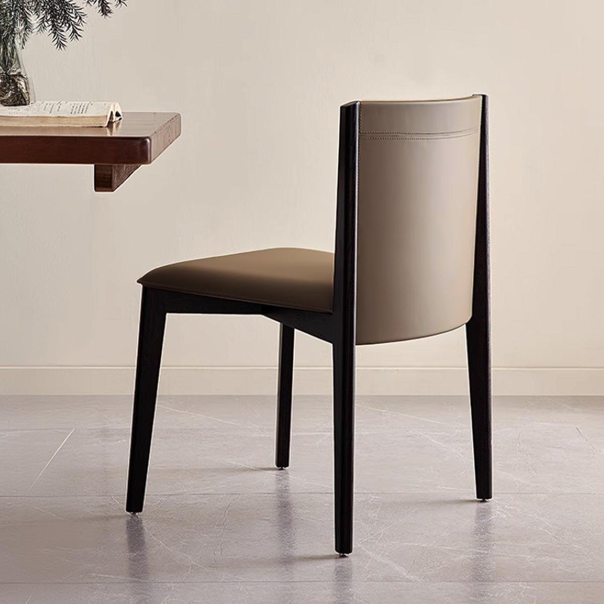 Dark saddle leather dining chair without arms, modern BEACON chair featuring sleek design and sturdy construction.