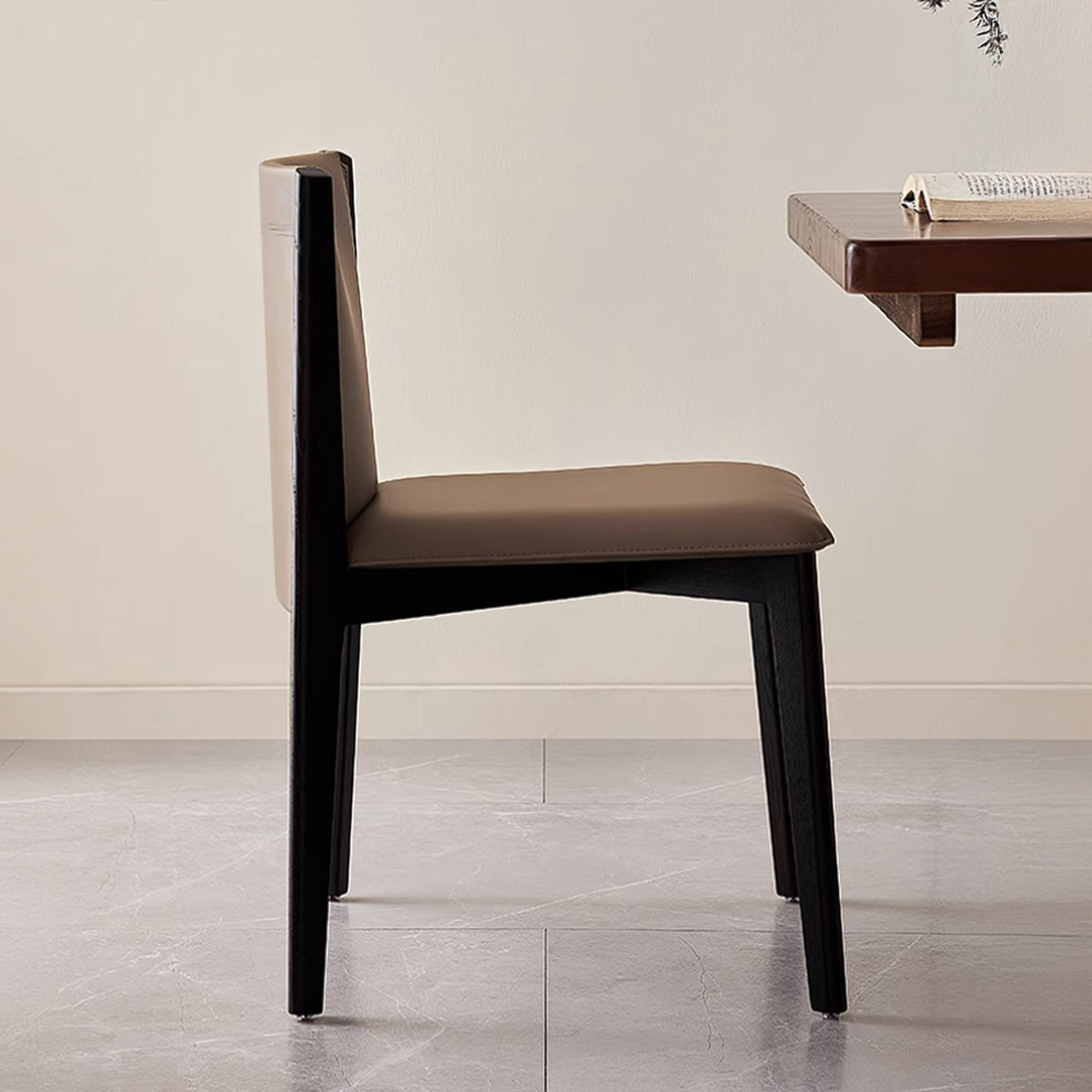 Dark saddle leather dining chair without arms, modern BEACON chair with sleek design and sturdy legs, suitable for dining rooms.