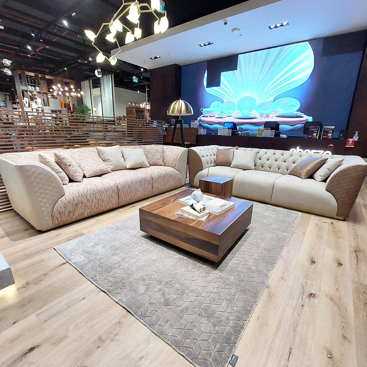 Delfina beige and brown 3-seater sofa by LODA Furniture, light brown fabric with plush cushions and wooden legs.