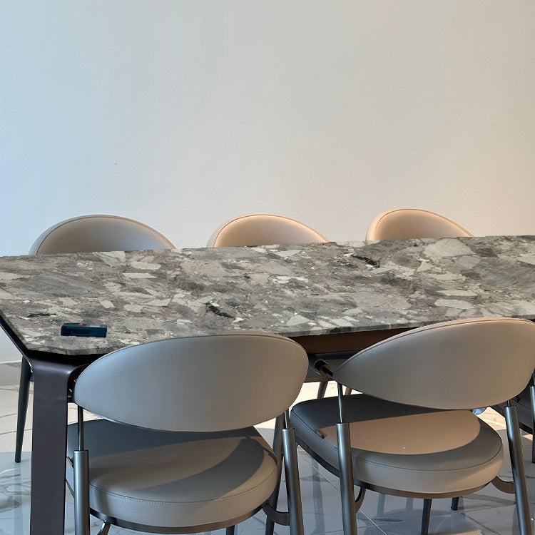 BEACON dining table with a natural stone top and steel legs, modern design for contemporary dining spaces.
