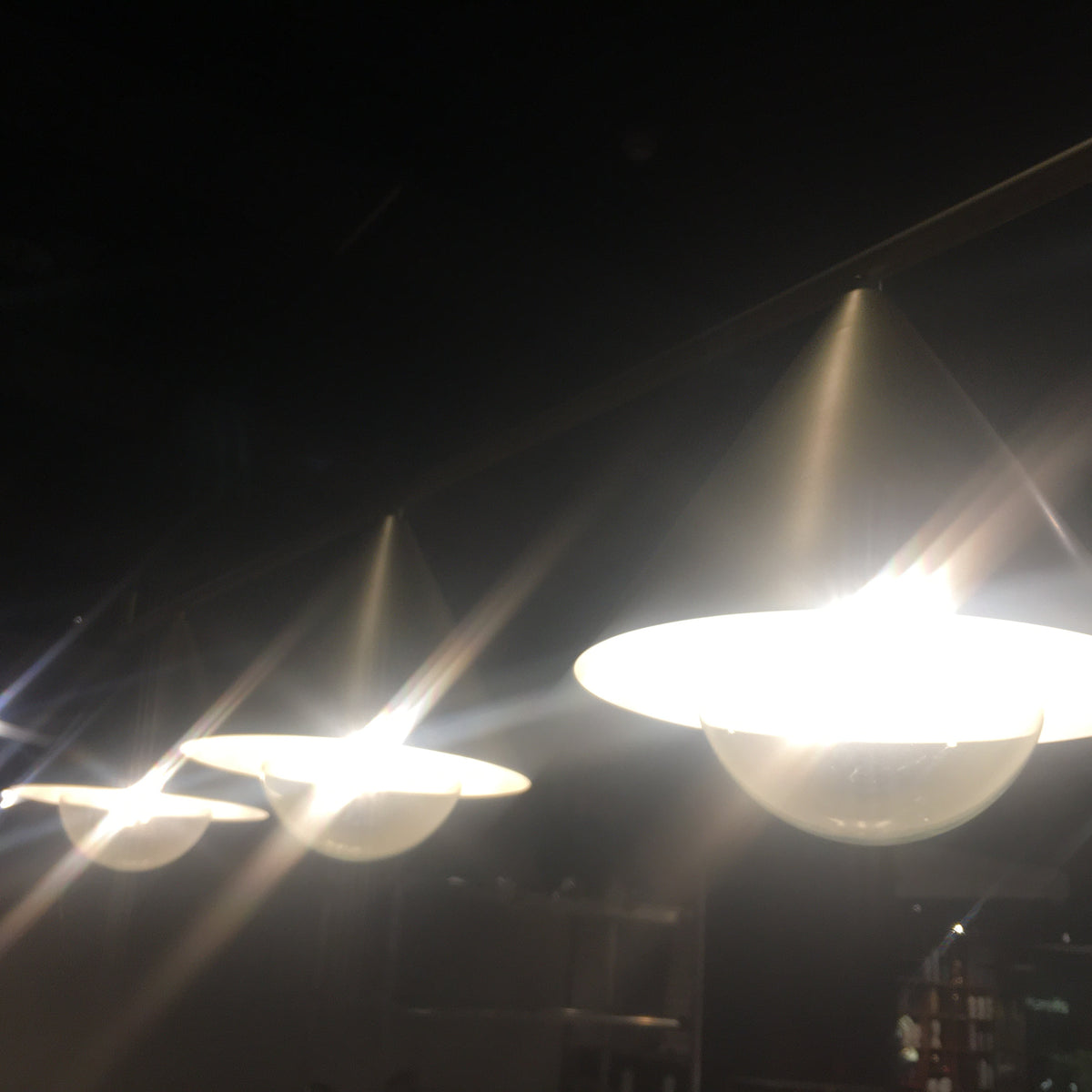 Display of the Andria 3 Heads Pendant Lamp by Beacon, showing its modern design and three hanging light fixtures.