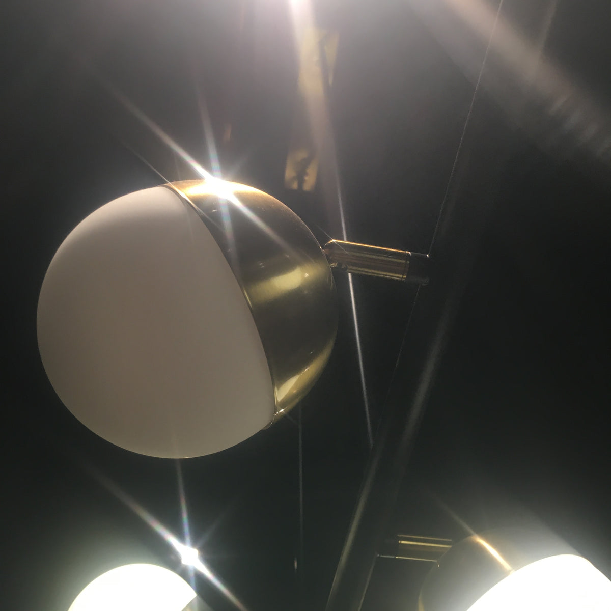 Display of Arvika 6 Heads Pendant Lamp by BEACON, showcasing modern chandelier with six hanging light fixtures.