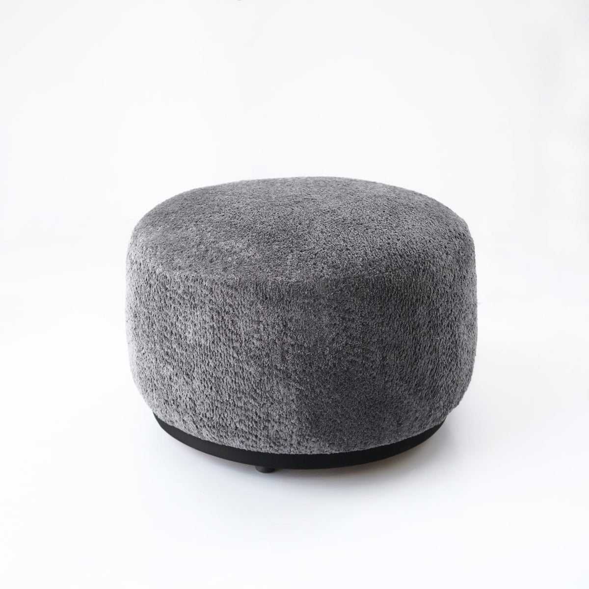 Gray Crown Pouf display item from Nakheel by SABRINO, showcasing a stylish, round upholstered floor cushion.