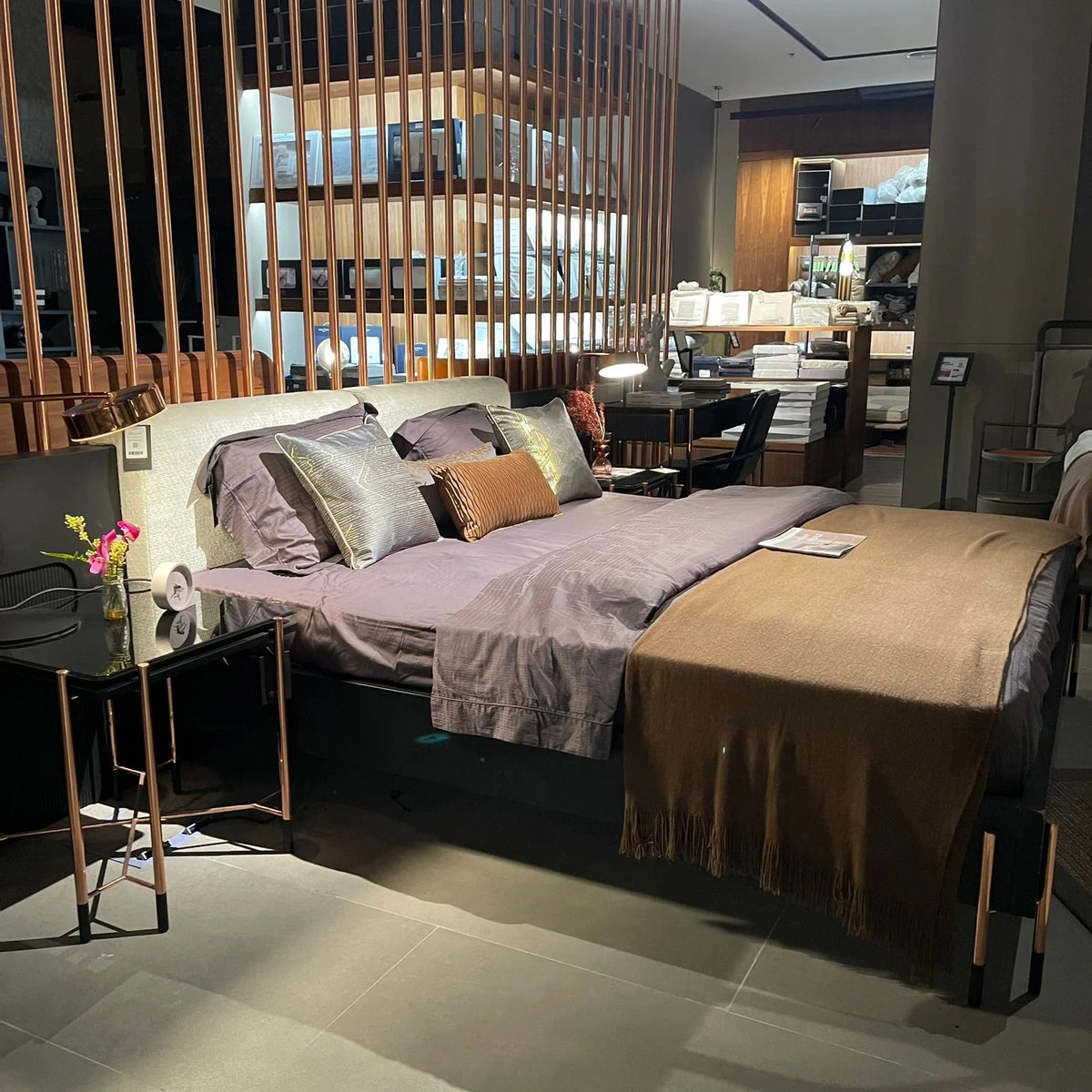 Display of the Dali King Size Bedstead by LODA FURNITURE, showcasing its modern design and sturdy frame in a showroom setting.