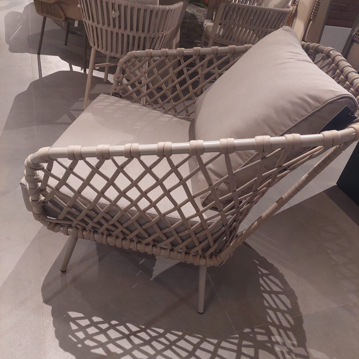 Display of the Evolve Outdoor Armchair by Beacon, showing its sleek design and durable outdoor seating features.