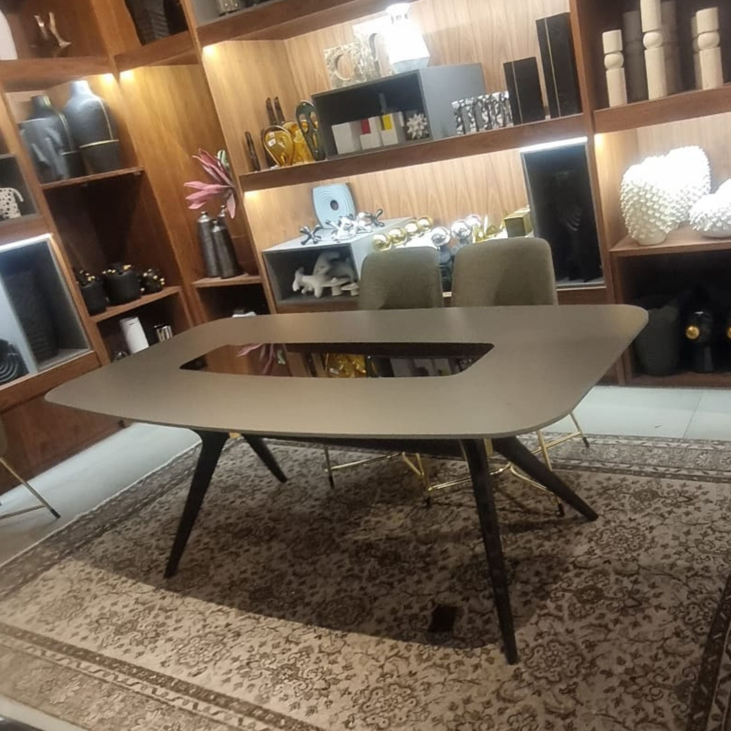Grey YOL Living dining table display item with sleek surface and modern design, shown from a side angle.