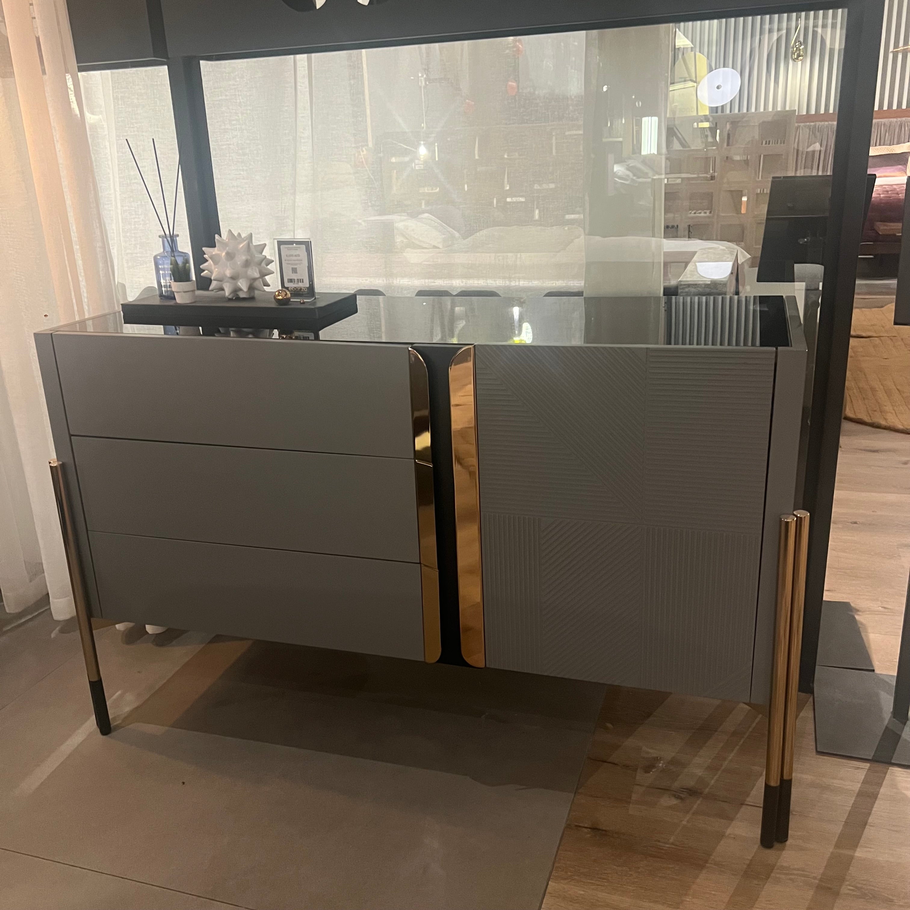 Grey dresser with matching mirror from YOL LIVING, showcasing a sleek, modern bedroom furniture display piece.