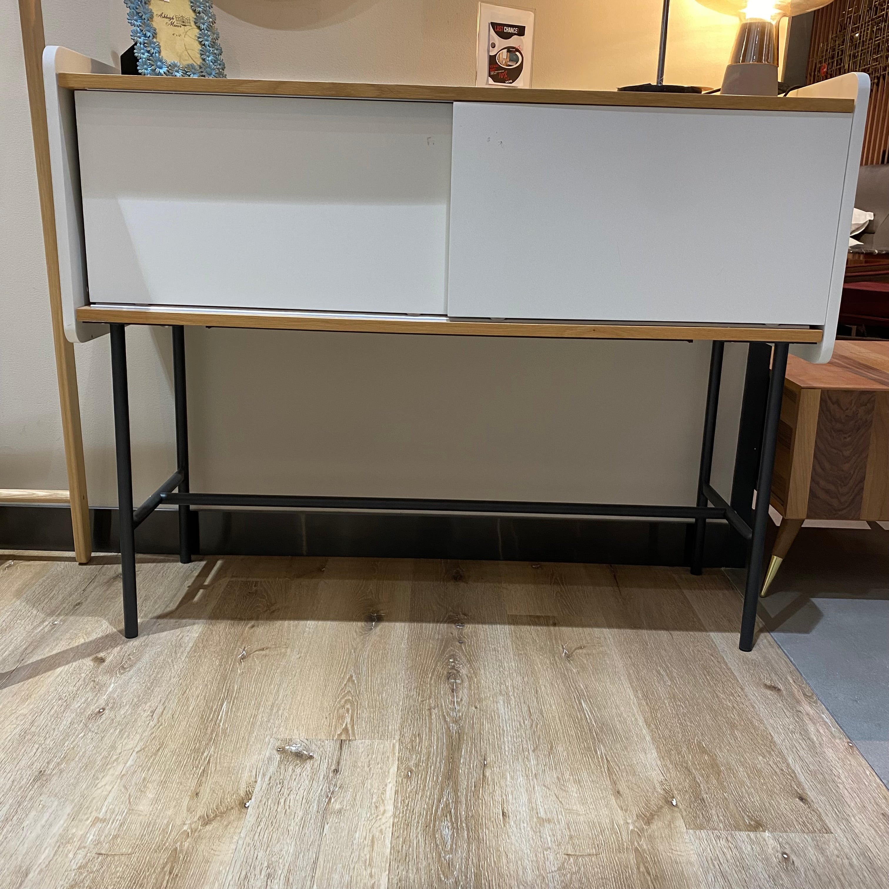 Display image of RUDI Jean Side Board console with sleek wooden finish, showcasing modern design and storage features.
