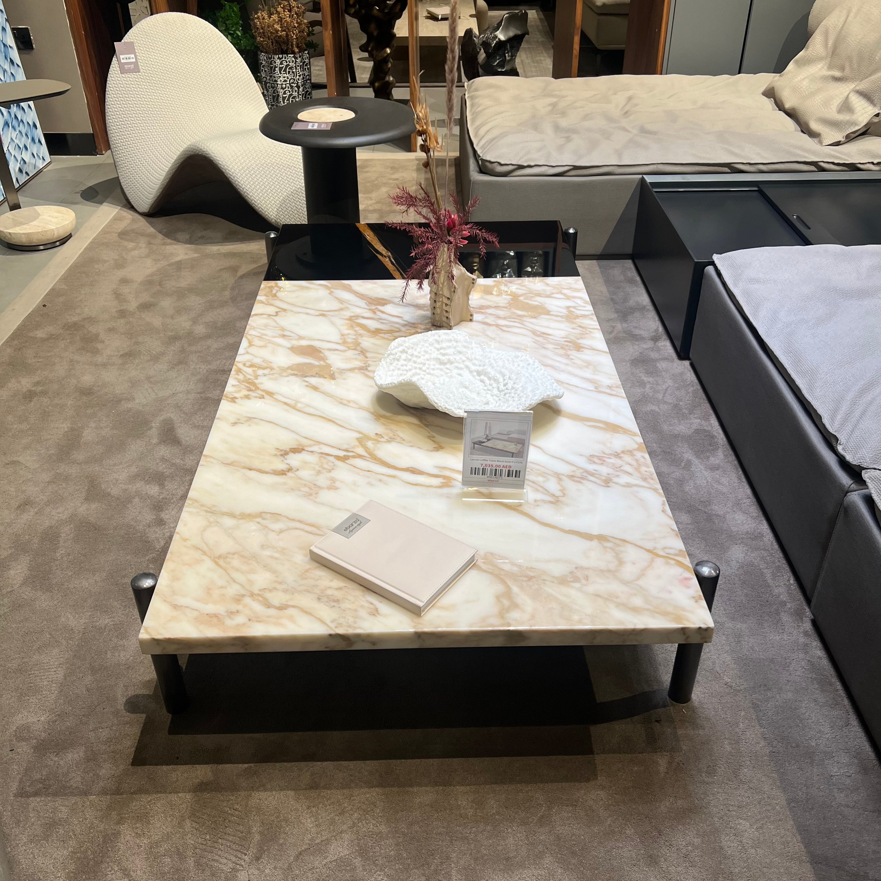 Black and gold Lauren coffee table display item by Beacon with sleek modern design and stylish finish.