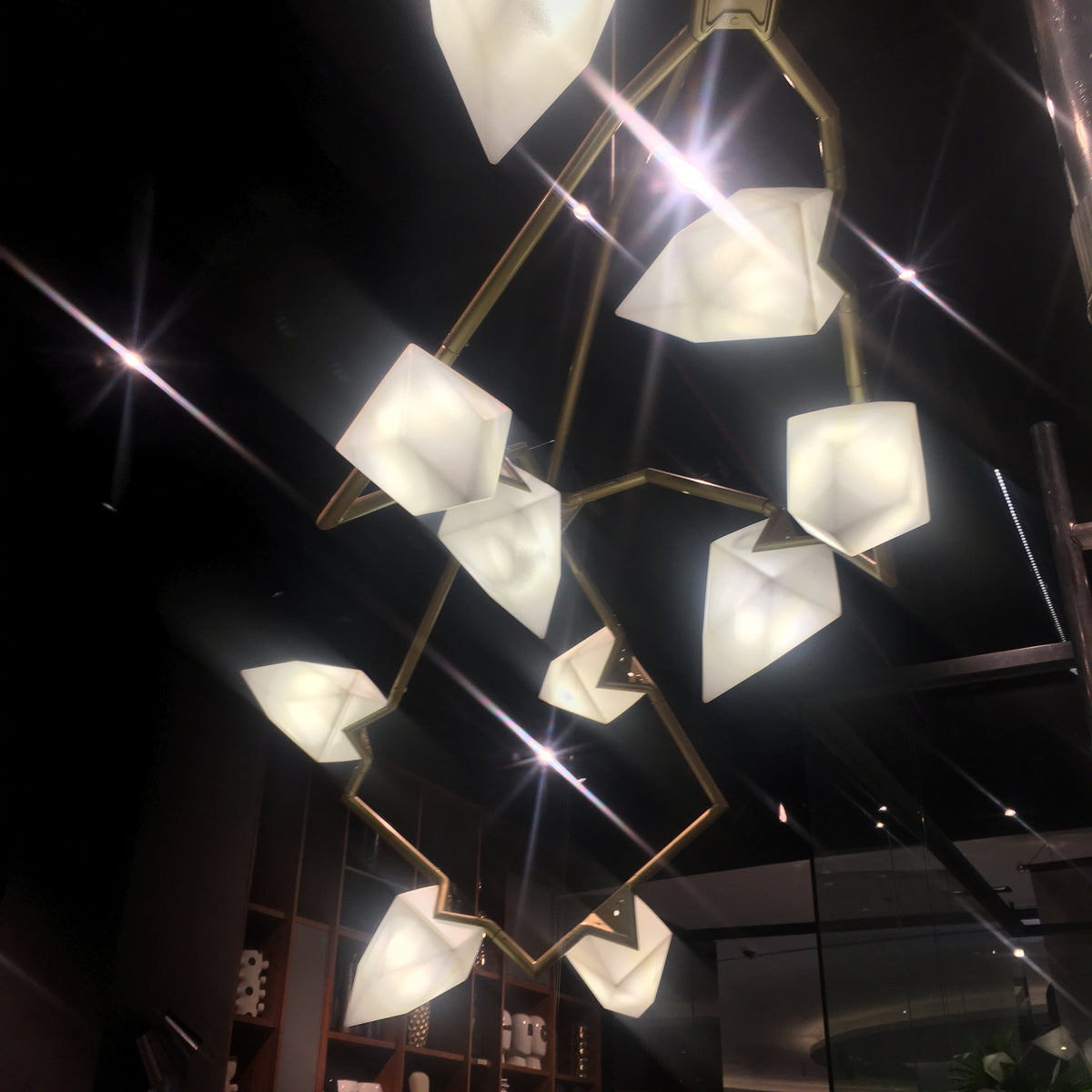 Display item of Masko 12-heads chandelier by Beacon, featuring a modern design with multiple hanging light fixtures.
